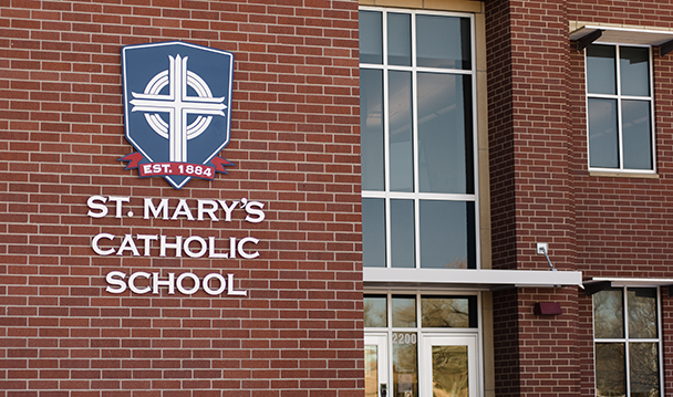 Exterior photo of a St. Mary's Catholic School sign on a brick building